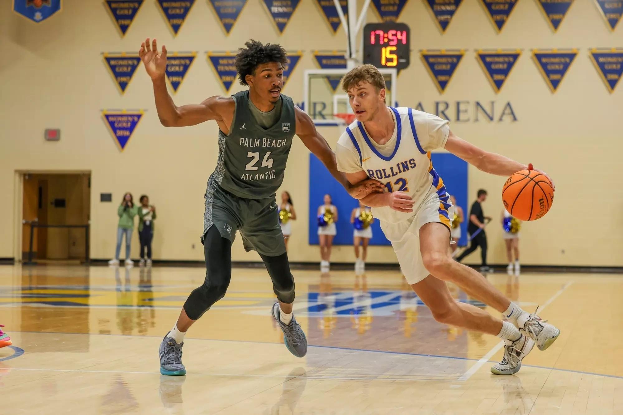 Sergey Grishaev drives to the hoop for Rollins.