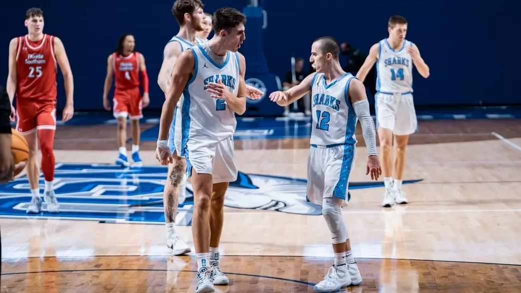 Nova Southeastern celebrates another DII men's basketball victory. 